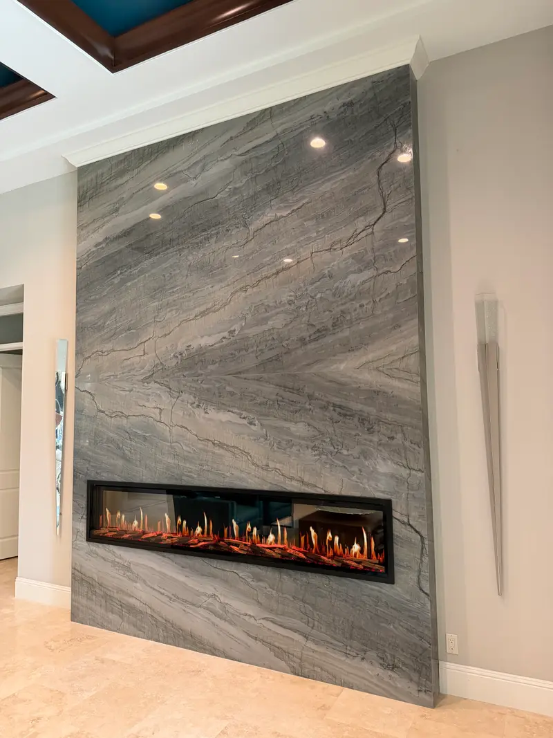 Linear electric fireplace set flush in a granite wall